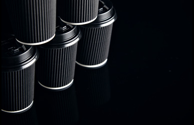 closeup view unlabeled set black take away cardboard paper cups closed with caps pyramid shape presented side 1